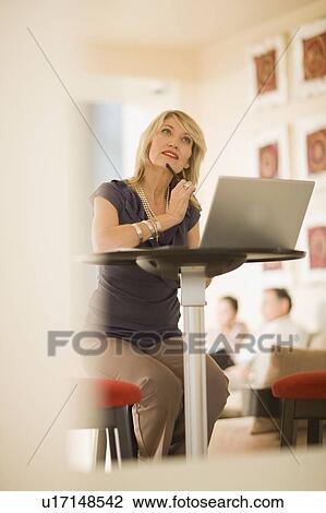 Stock Image - Businesswoman working on laptop. Fotosearch