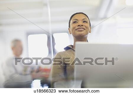 Businesswoman working on laptop View Large Photo Image Stock Image - Businesswoman working on laptop. Fotosearch