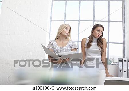 Businesswomen arguing in office View Large Photo Image Stock Photograph - Businesswomen arguing in office. Fotosearch