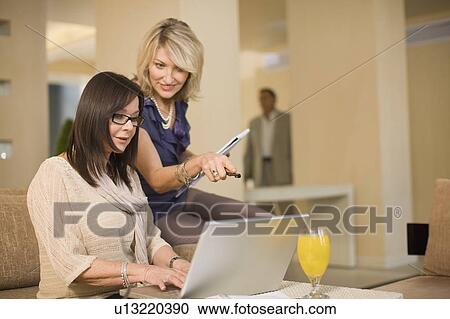 Businesswomen working in lounge View Large Photo Image Stock Image - Businesswomen working in lounge. Fotosearch