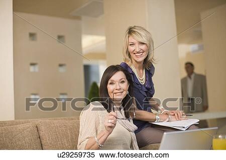 Businesswomen working in lounge View Large Photo Image Stock Photography - Businesswomen working in lounge. Fotosearch