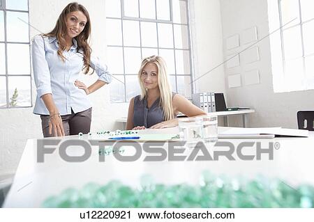 Stock Image - Businesswomen working with glass beads. Fotosearch
