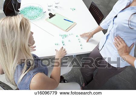 Stock Photo - Businesswomen working with glass beads. Fotosearch