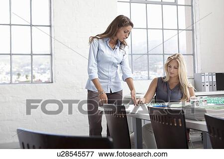 Stock Photo - Businesswomen working with glass beads. Fotosearch