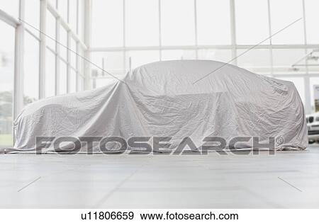 Stock Photo - Car covered in cloth in garage. Fotosearch