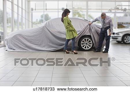 Car salesman displaying car for woman View Large Photo Image Stock Image - Car salesman displaying car for woman. Fotosearch