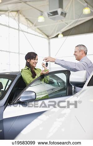 Car salesman giving keys to customer View Large Photo Image Stock Photo - Car salesman giving keys to customer. Fotosearch