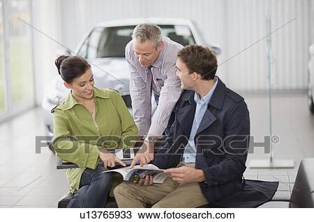 Car salesman talking with couple View Large Photo Image Stock Image - Car salesman talking with couple. Fotosearch