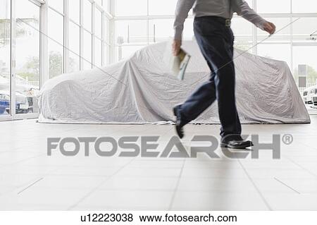 Car salesman walking in showroom View Large Photo Image Stock Photo - Car salesman walking in showroom. Fotosearch