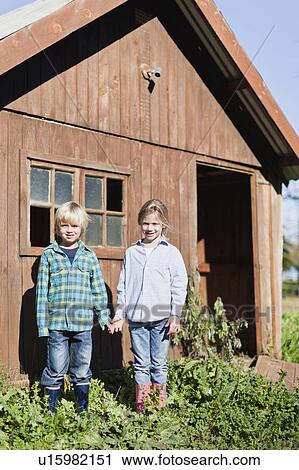 Children holding hands outside shed View Large Photo Image Stock Image - Children holding hands outside shed. Fotosearch