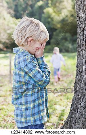 Children playing hide and seek outdoors View Large Photo Image Stock Image - Children playing hide and seek outdoors. Fotosearch