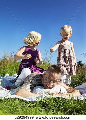Children playing with father outdoors View Large Photo Image Stock Photo - Children playing with father outdoors. Fotosearch