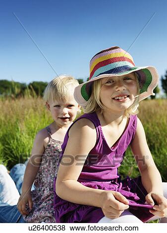 Children sitting on father outdoors View Large Photo Image Stock Photo - Children sitting on father outdoors. Fotosearch