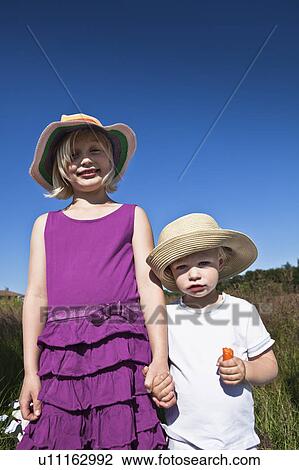 Children walking hand-in-hand outdoors View Large Photo Image Stock Image - Children walking hand-in-hand outdoors. Fotosearch