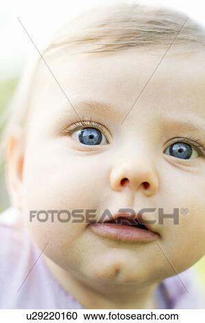Stock Image - Close up of baby’s face. Fotosearch