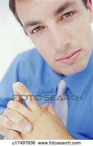 Stock Photograph - Close up of businessman thinking. Fotosearch