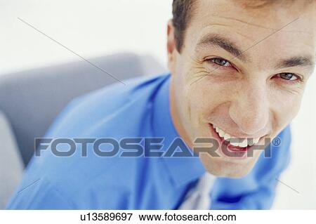 Stock Photo - Close up of businessman’s smiling face. Fotosearch