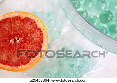 Picture - Close up of halved grapefruit. Fotosearch