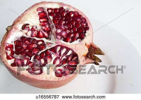 Close up of halved pomegranate View Large Photo Image Stock Photo - Close up of halved pomegranate. Fotosearch