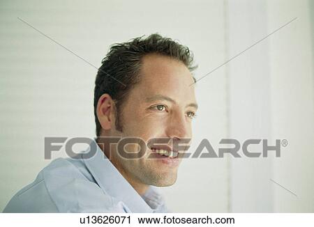 Stock Image - Close up of smiling man’s face. Fotosearch