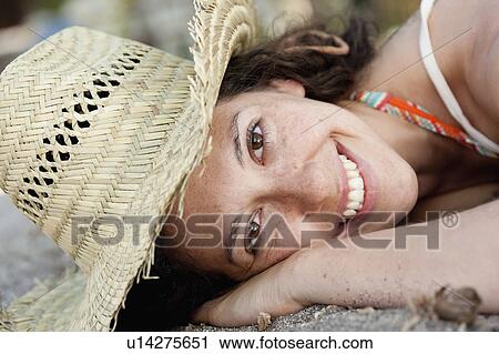 Close up of smiling woman wearing sunhat View Large Photo Image Stock Image - Close up of smiling woman wearing sunhat. Fotosearch