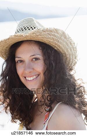 Stock Photograph - Close up of smiling woman wearing sunhat. Fotosearch