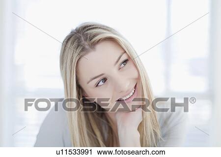 Stock Image - Close up of smiling woman’s face. Fotosearch