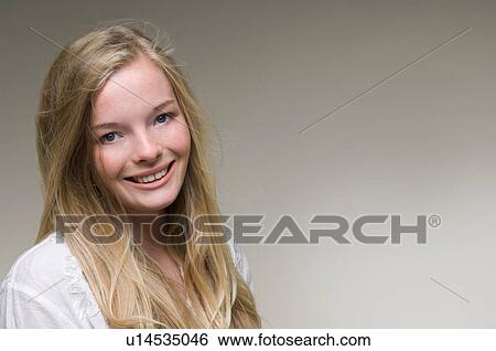 Stock Photograph - Close up of teenage girl’s smiling face. Fotosearch