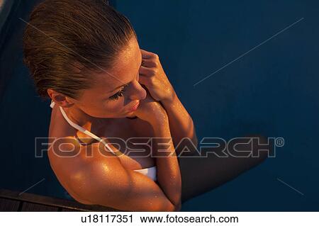 Stock Image - Close up of woman in swimming pool. Fotosearch