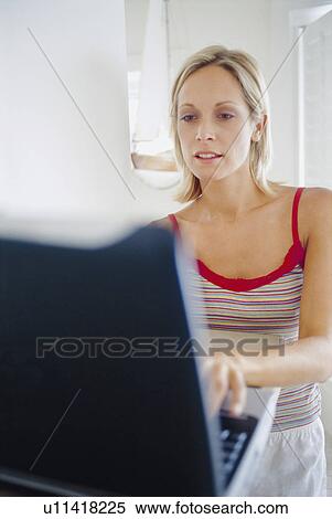 Stock Photography - Close up of woman using laptop. Fotosearch