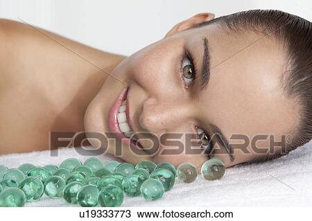 Close up of woman with glass beads View Large Photo Image Stock Image - Close up of woman with glass beads. Fotosearch