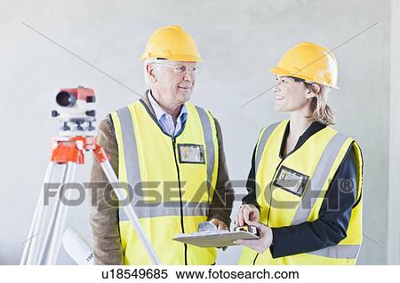 Construction workers talking on site View Large Photo Image Stock Photography - Construction workers talking on site. Fotosearch