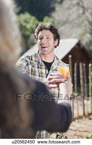 Couple drinking juice and gardening View Large Photo Image Stock Image - Couple drinking juice and gardening. Fotosearch