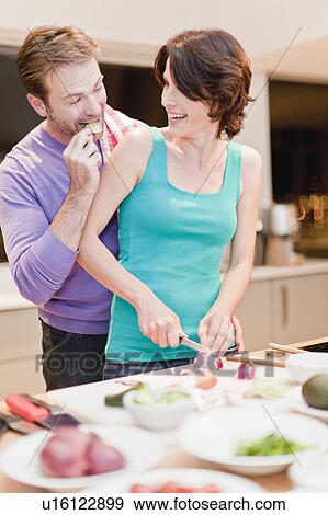 Couple eating and cooking dinner View Large Photo Image Stock Photo - Couple eating and cooking dinner. Fotosearch