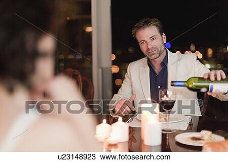 Couple having romantic dinner at home View Large Photo Image Stock Image - Couple having romantic dinner at home. Fotosearch