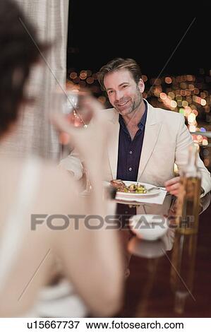 Couple having romantic dinner at home View Large Photo Image Stock Photo - Couple having romantic dinner at home. Fotosearch
