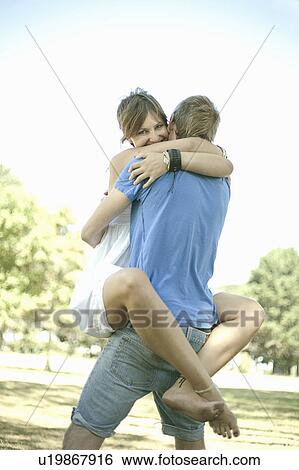 Couple hugging in park View Large Photo Image Stock Photograph - Couple hugging in park. Fotosearch