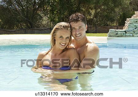 Couple hugging in swimming pool View Large Photo Image Stock Image - Couple hugging in swimming pool. Fotosearch