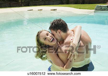 Couple hugging in swimming pool View Large Photo Image Stock Image - Couple hugging in swimming pool. Fotosearch