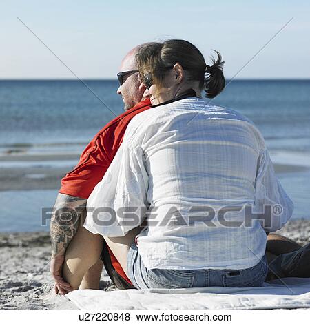 Stock Photo - Couple hugging on beach. Fotosearch