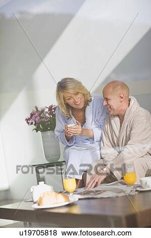 Couple in bathrobes having breakfast View Large Photo Image Stock Photo - Couple in bathrobes having breakfast. Fotosearch