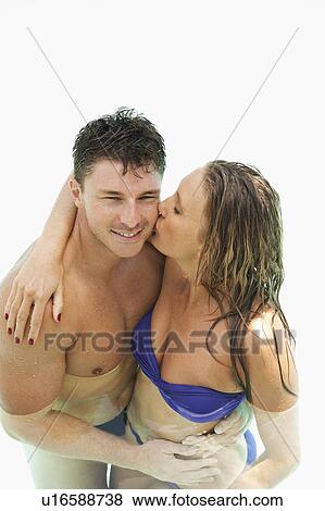 Couple kissing in swimming pool View Large Photo Image Stock Photo - Couple kissing in swimming pool. Fotosearch