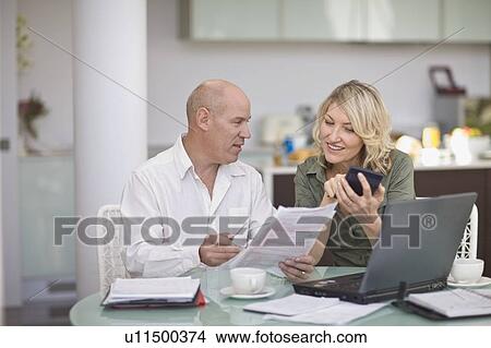 Couple paying their bills at home View Large Photo Image Picture - Couple paying their bills at home. Fotosearch