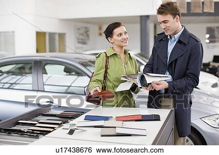 Couple picking out swatches in showroom View Large Photo Image Stock Photograph - Couple picking out swatches in showroom. Fotosearch