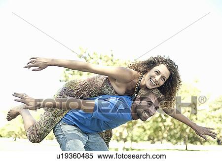 Couple playing airplane in park View Large Photo Image Stock Photography - Couple playing airplane in park. Fotosearch