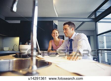 Couple relaxing in kitchen View Large Photo Image Stock Image - Couple relaxing in kitchen. Fotosearch