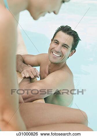 Couple relaxing in swimming pool View Large Photo Image Stock Photograph - Couple relaxing in swimming pool. Fotosearch