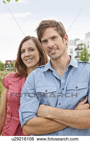 Stock Photo - Couple standing together outdoors. Fotosearch