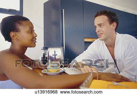 Stock Photo - Couple talking in kitchen. Fotosearch