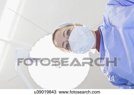 Stock Image - Doctor examining patient on table. Fotosearch